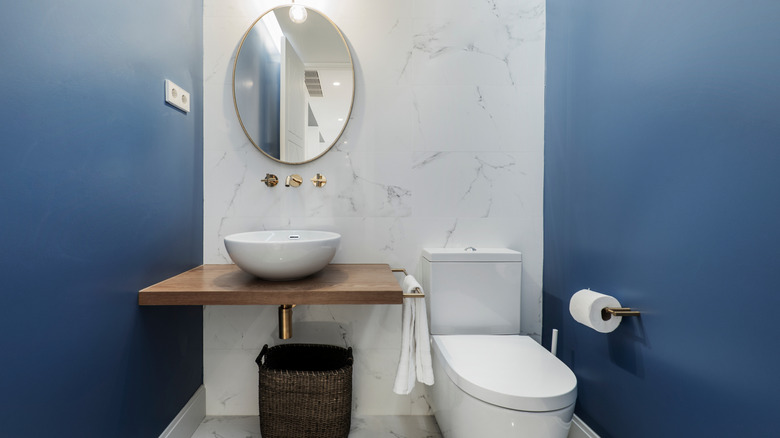 Deep blue bathroom with marble wall