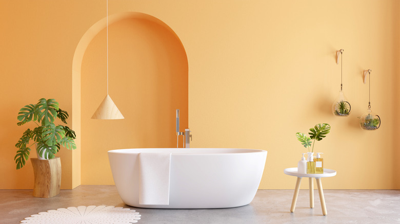 Light orange bathroom with white tub