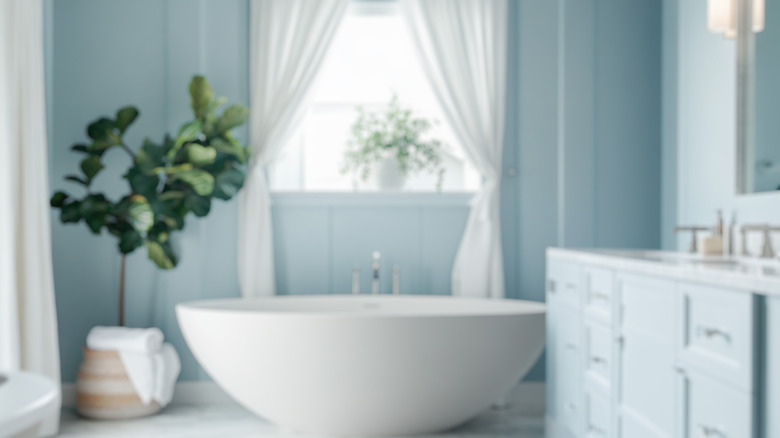 Spa blue bathroom surrounded by plants