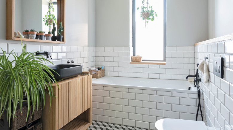 Light gray bathroom features wood accents