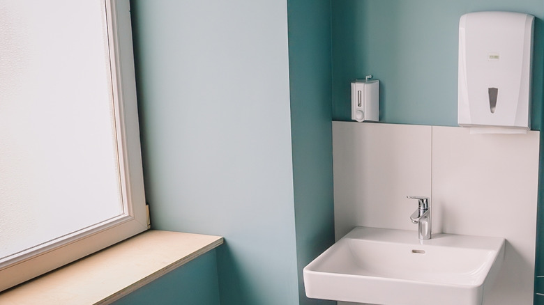 Teal bathroom with a white sink