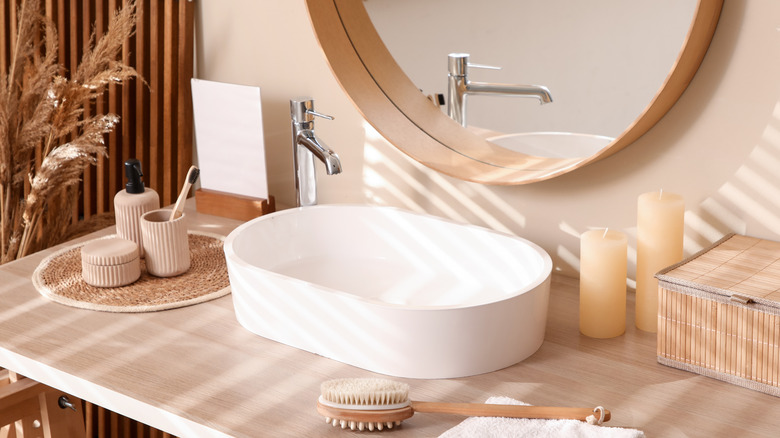 Beige bathroom with a wood vanity and white sink