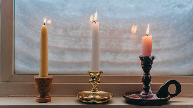 Taper candles on windowsill