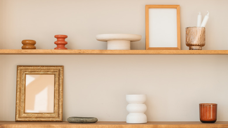 Empty frames on minimalist decorated shelves