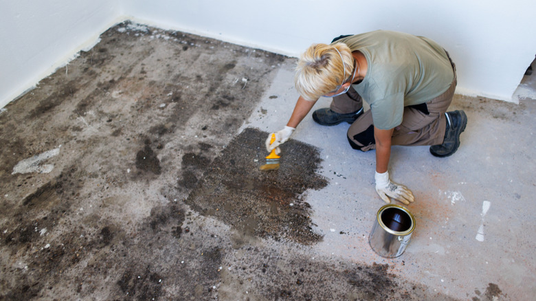 A person painting the floor