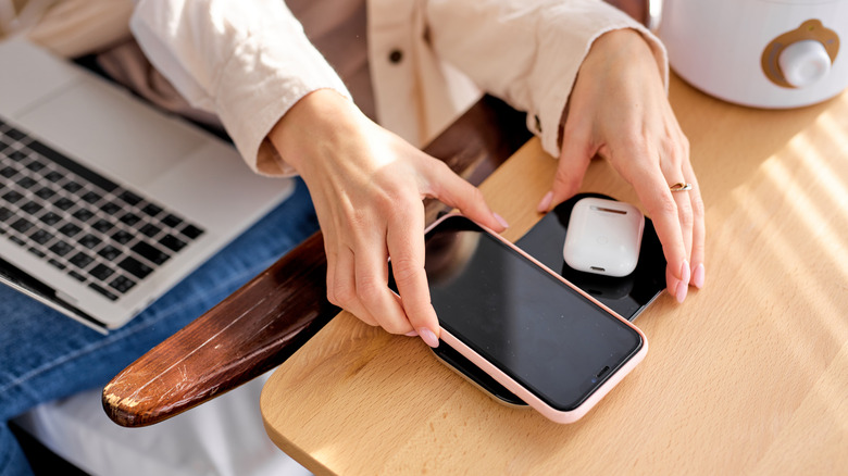 person using wireless charger
