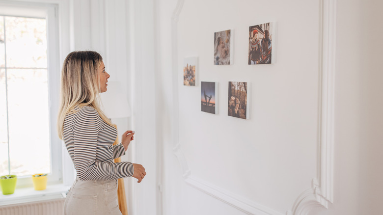 woman putting up photos