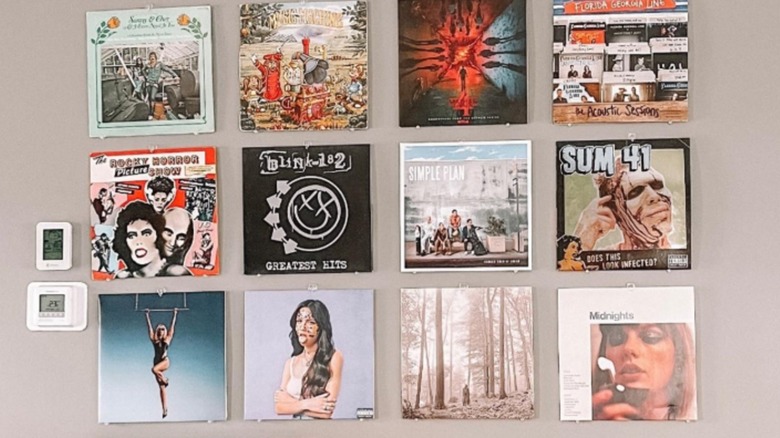 Record albums arranged in grid on a wall.