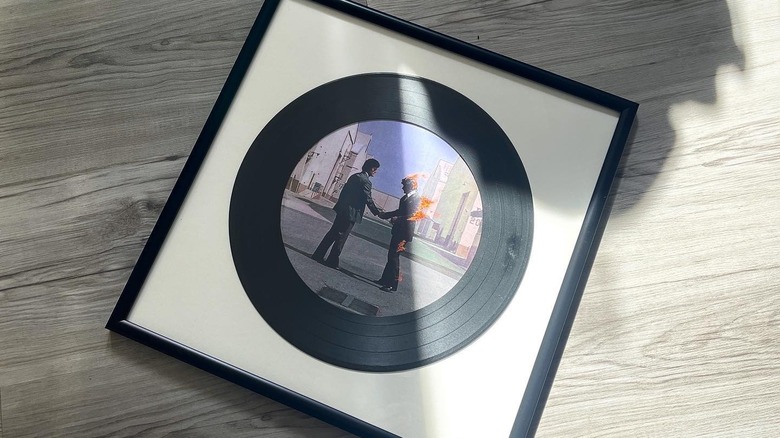 A record album used as a mat for a framed photo.