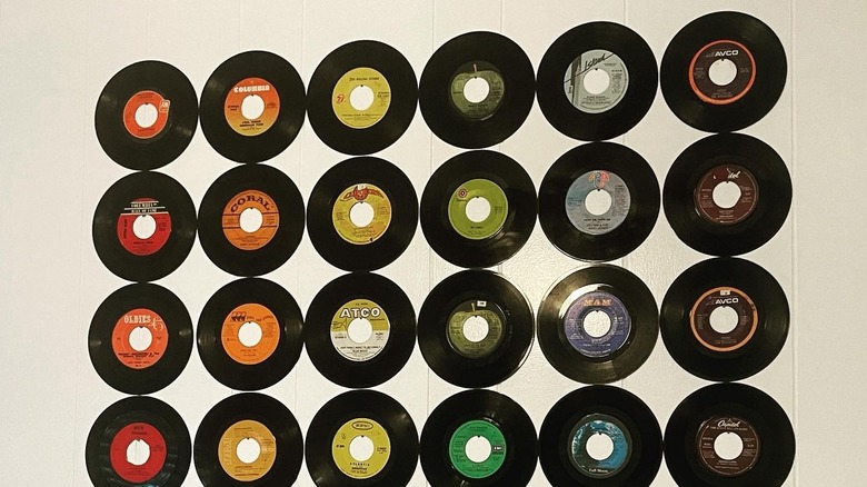 Vinyl records arranged on the wall by color.