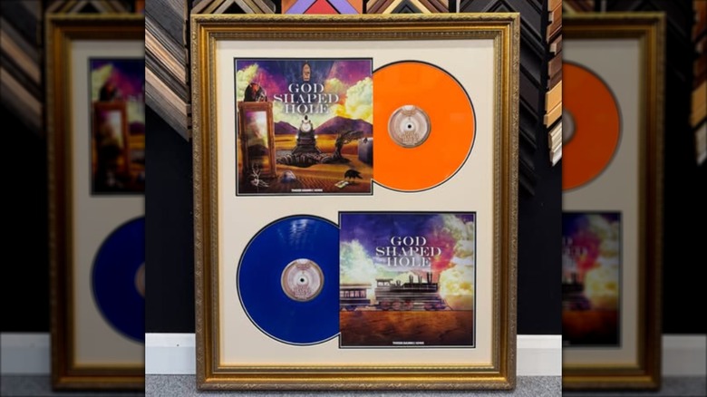 Records displayed in a gold frame.