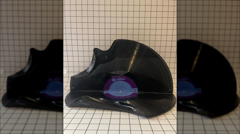 A record album folded into a wall shelf.