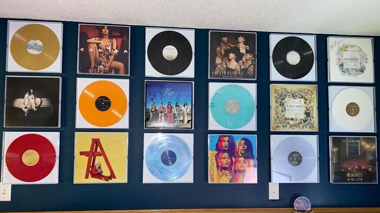 Clear acrylic frames holding vinyl albums and covers.