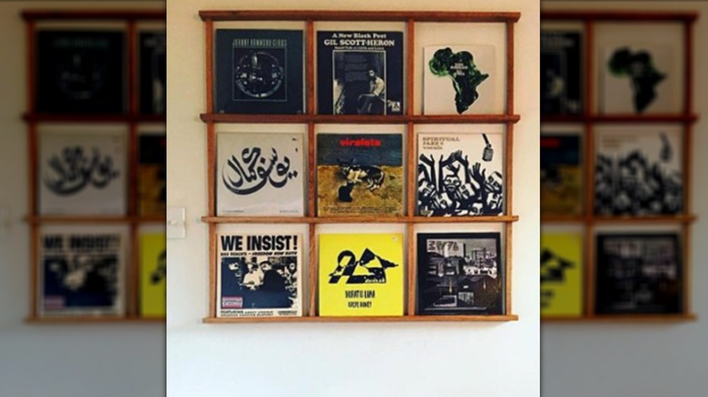 A wooden rack display of vinyl records.
