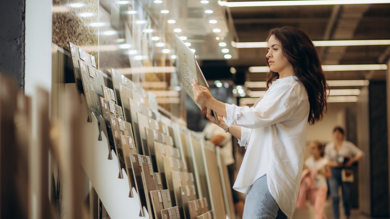 Person choosing between different tiles in a store