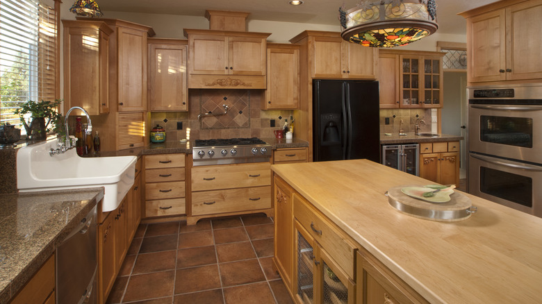 A traditional kitchen with large quarry tile floors and backsplashes.