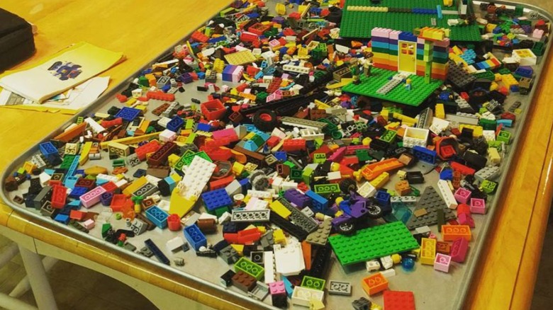 A metal oil drip tray with building blocks on it.