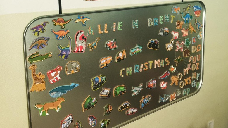 An oil drip tray with kid magnets on it.