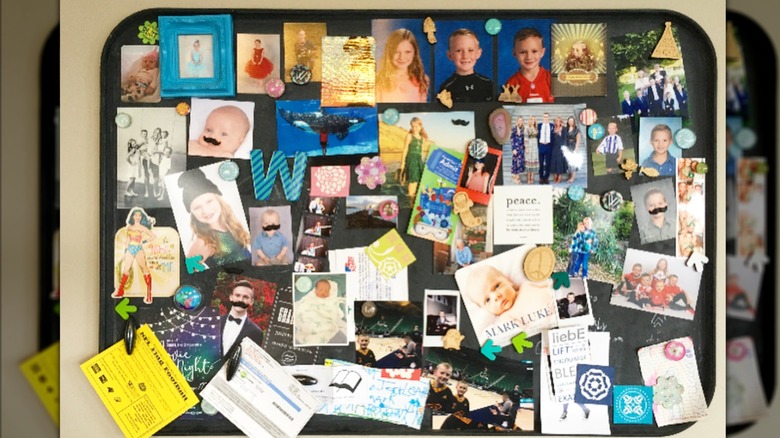A black drip tray covered in family photos.