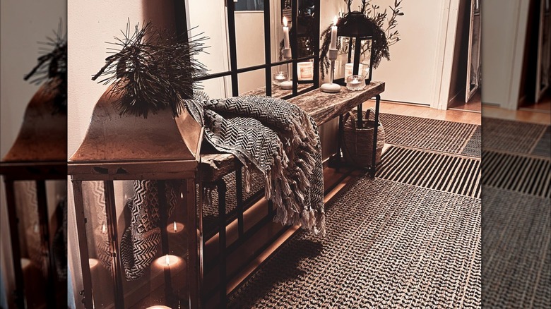 A dark and moody entryway with boho decor