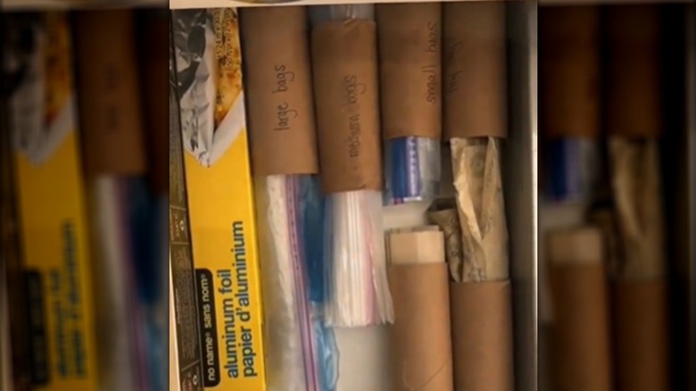 A row of rolls holding plastic baggies in a drawer.