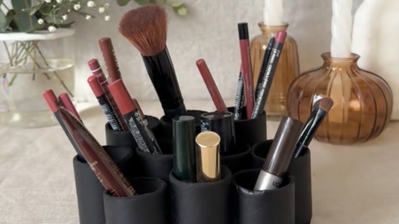 A black toilet-paper-roll makeup organizer.