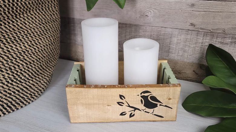 Wooden box made with Dollar Tree pallets on the end and candles inside