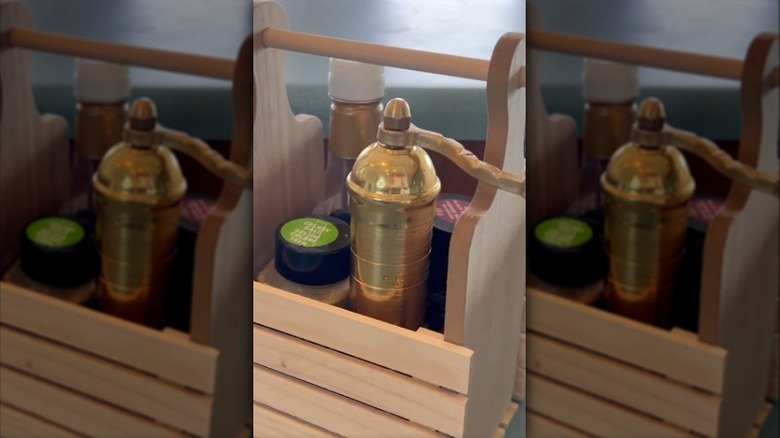 Pallet on the table with a mini cutting board being glued to the side and the finished product with bar supplies in it