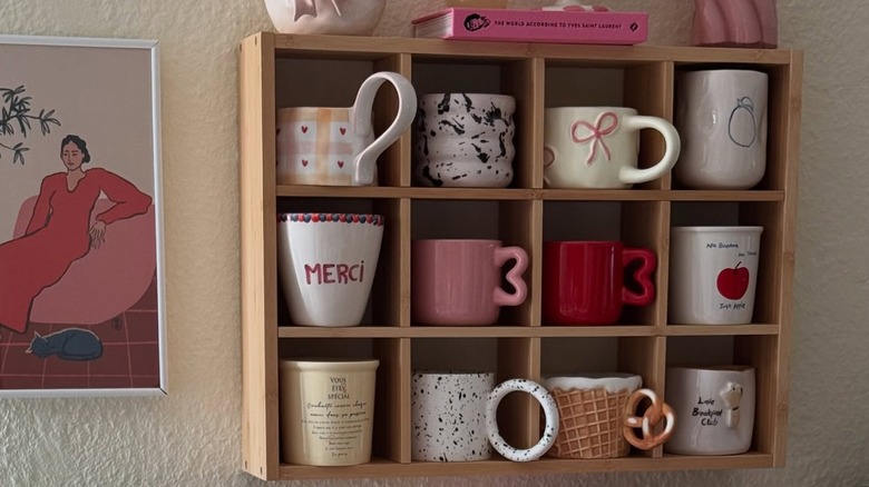 Large mugs in a shelf with dividers