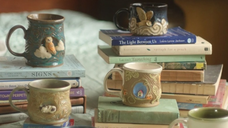 Designer mugs placed on book stacks