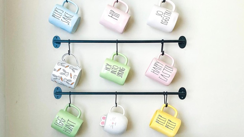 Colored mugs hanging from hooks