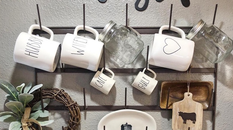 Mugs displayed on a black rack
