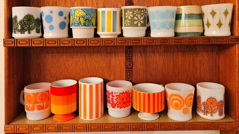 A mixed mug collection on a shelf