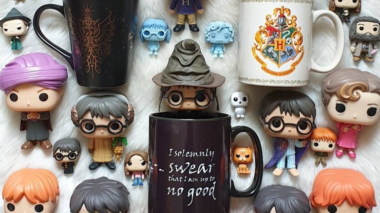 Mugs on a wall along with miniature toys