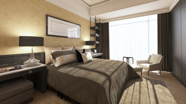 A modern bedroom with dark-toned aesthetic, decor, and linens.