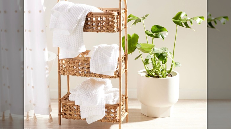 Three-tiered basket stand in bathroom setting