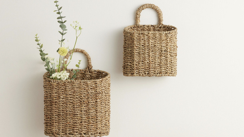 Wall baskets hanging with flowers in them