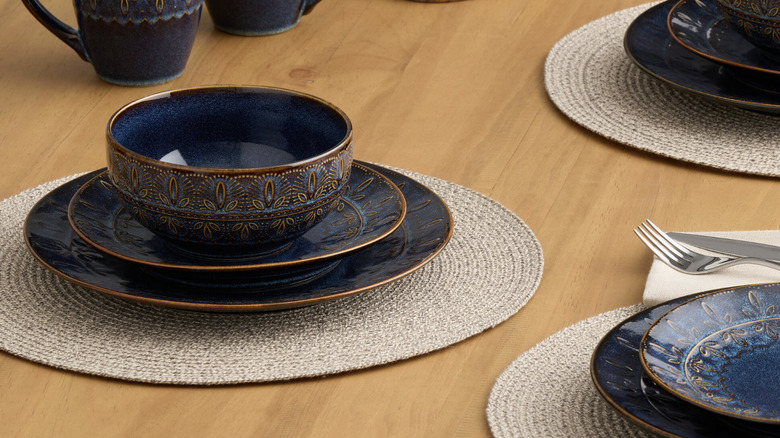 Embossed salad plate on a wooden table with other dishes