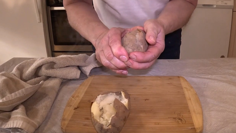 A woman baking and opening up 'Butte' potatoes