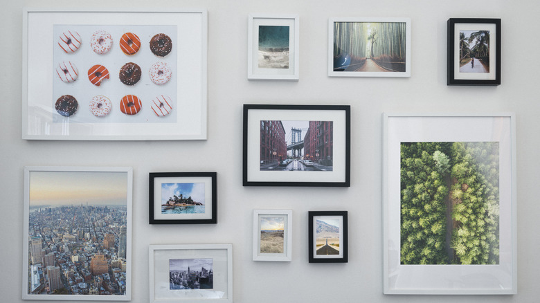 A gallery wall with random photos and different frames.