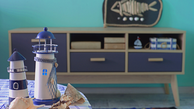 A nautical themed room with a credenza and table.