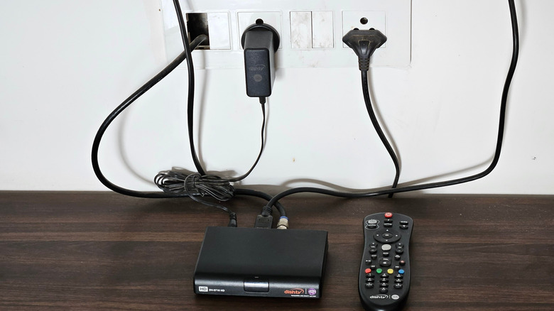 Visible router and cords plugged into a wall.