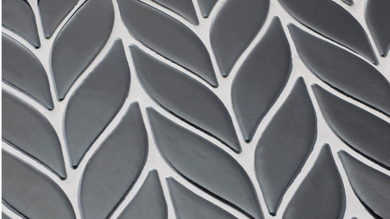 A close up of curved chevrons with a light gray grout