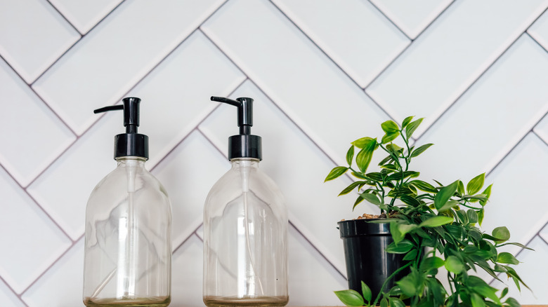 White herringbone tile with darker grout on a bathroom wall