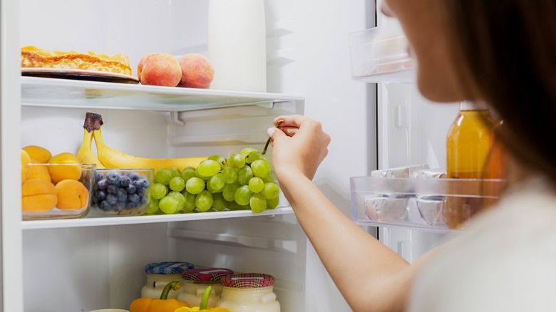 woman with organized fridge