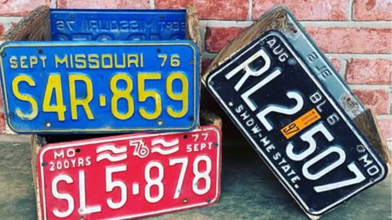 Colorful planters made from old car license plates.