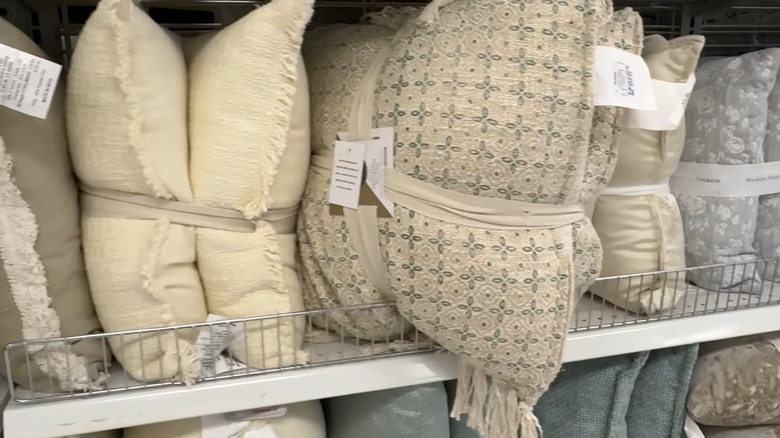 Closeup of muted color pillows for sale in a Ross store