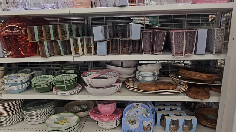 Sets of dishes and glasses in various colors and designs on store shelves of Ross