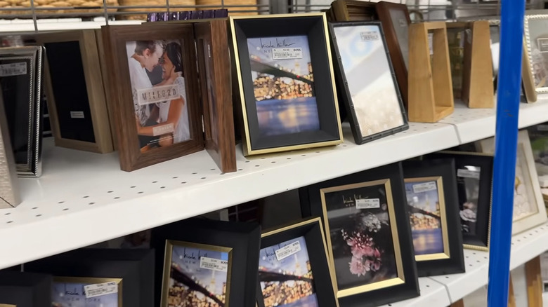 Picture frames made of metal and wood accents on shelves of a Ross Dress for Less