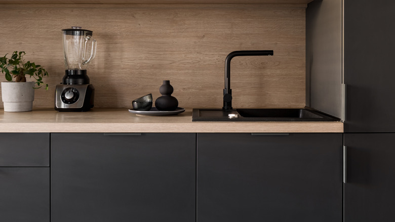 Wood cabinets with the same wood for backsplash and countertop.